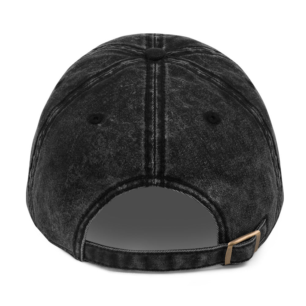 Back of the black vintage cap showing the adjustable antique-brass buckle
