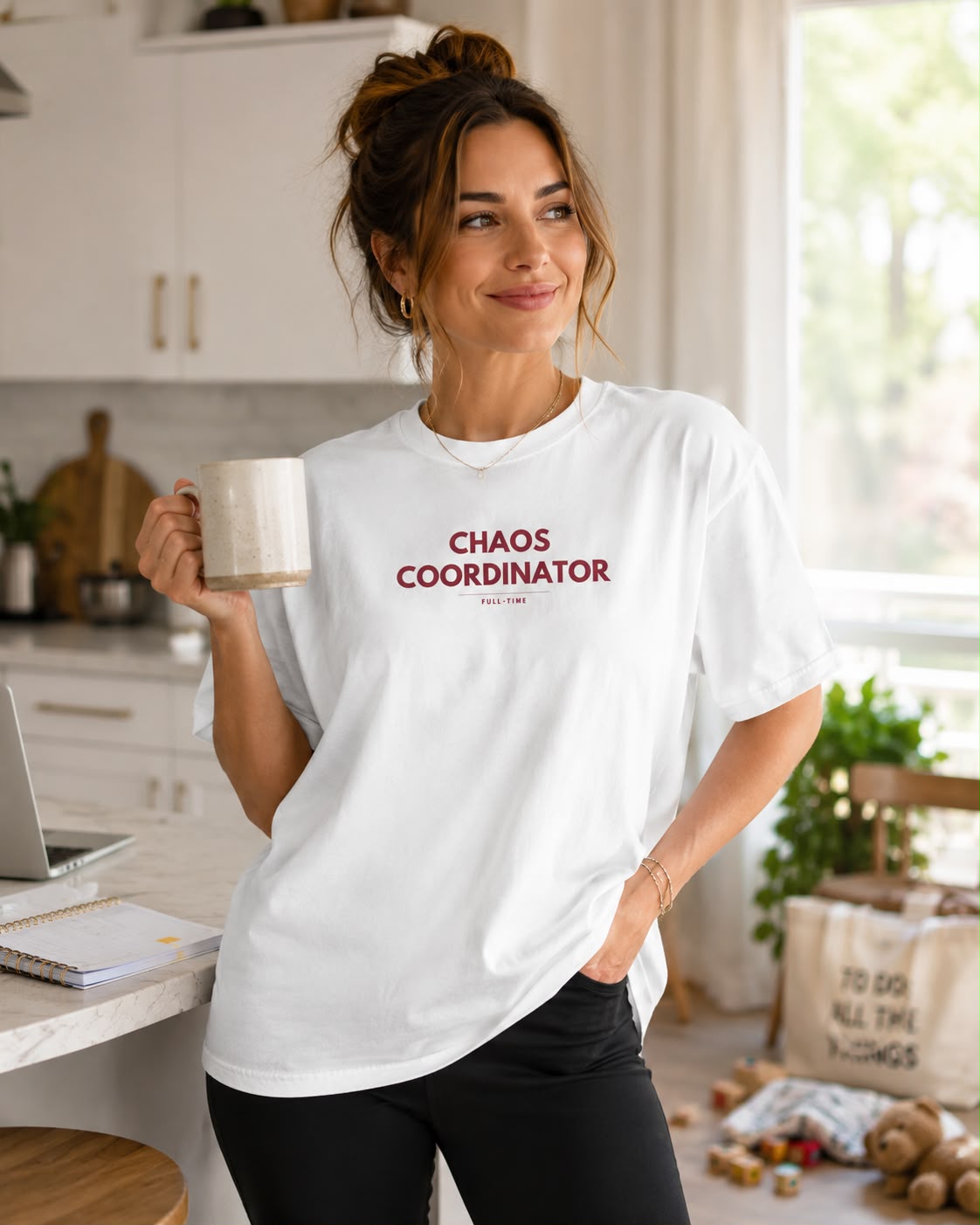 Chaos Coordinator tee lifestyle photo, female model, bright kitchen
