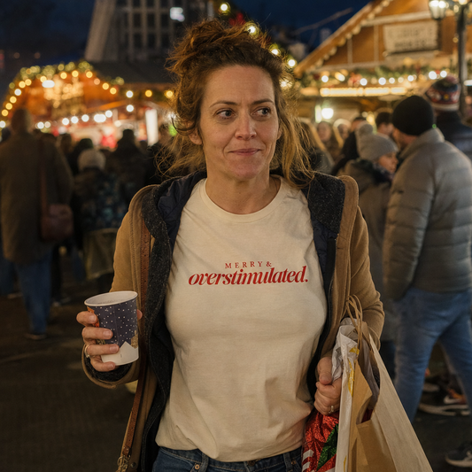 Merry & Overstimulated tee worn at a crowded Christmas market