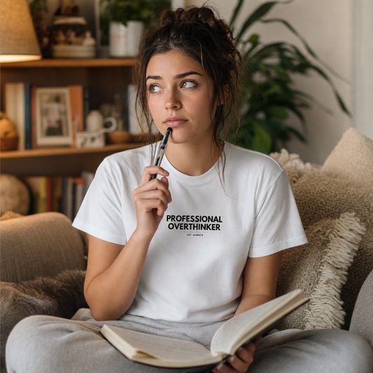 Professional Overthinker tee lifestyle photo, woman thinking on sofa